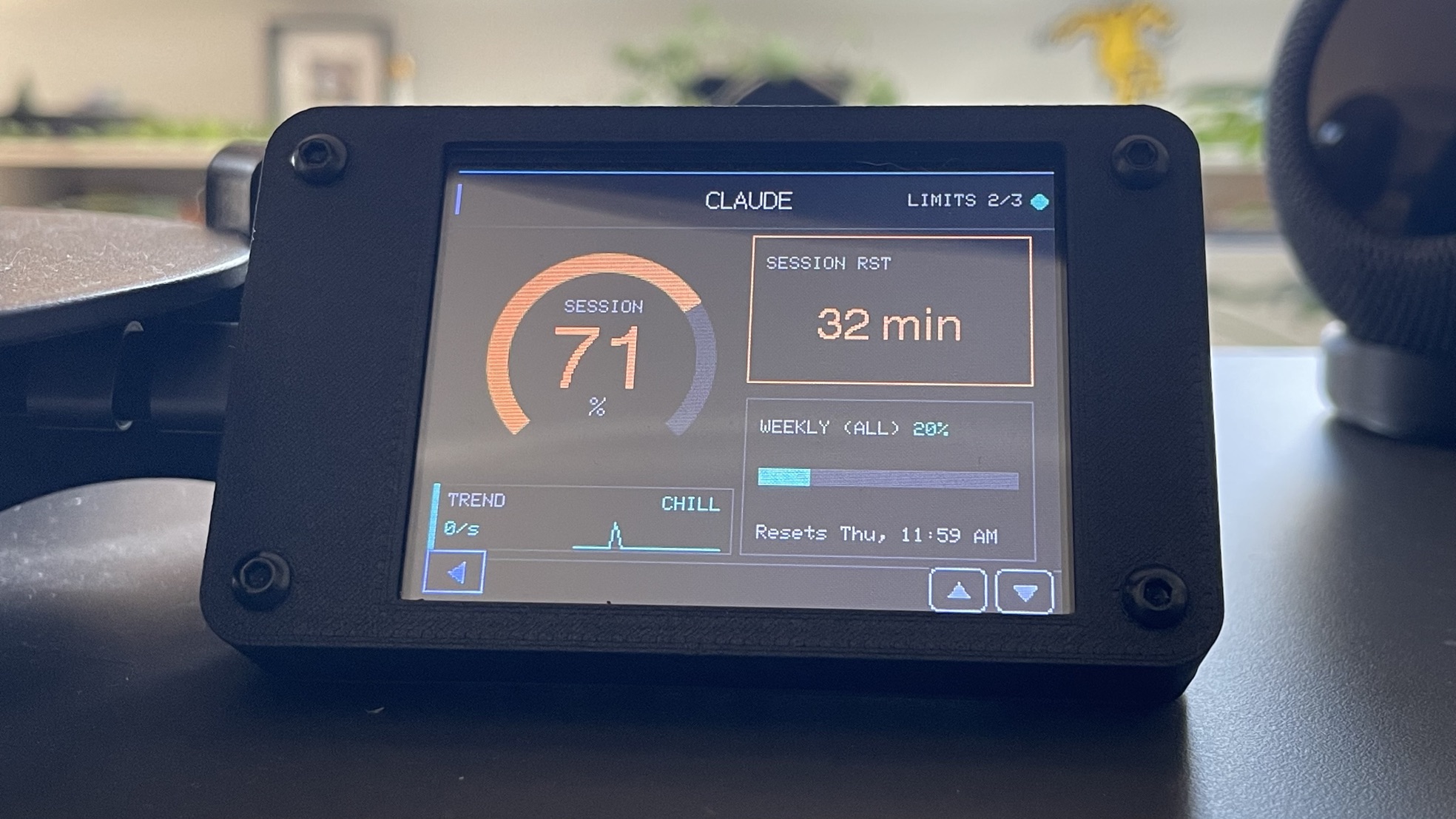 The Claude LIMITS page on the device: a session ring gauge at 71 percent, a SESSION RST box reading 32 min, the weekly bar at 20 percent, and a TREND sparkline labelled CHILL.
